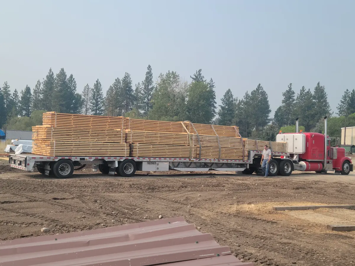 Trailer loaded with stacks of cut lumber