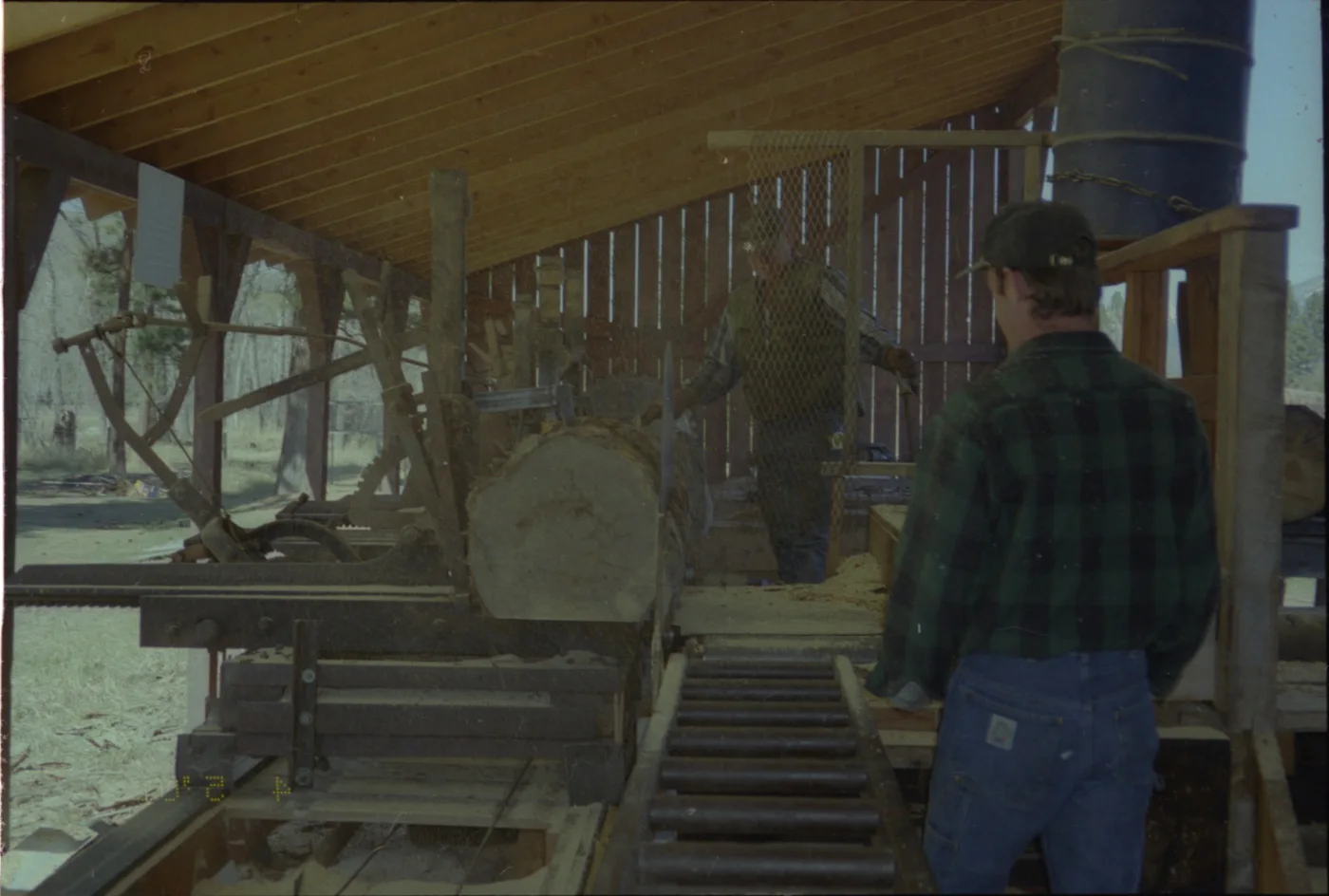 Two mill workers operating the original Camas Creek circle sawmill